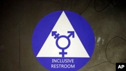 A sticker designates a gender neutral bathroom at Nathan Hale high school, May 17, 2016, in Seattle.